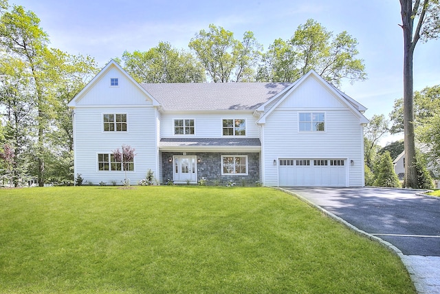59 Thornhill Rd, Fairfield, CT 06824 - view of front of house featuring driveway, an attached garage, stone siding, and a front yard