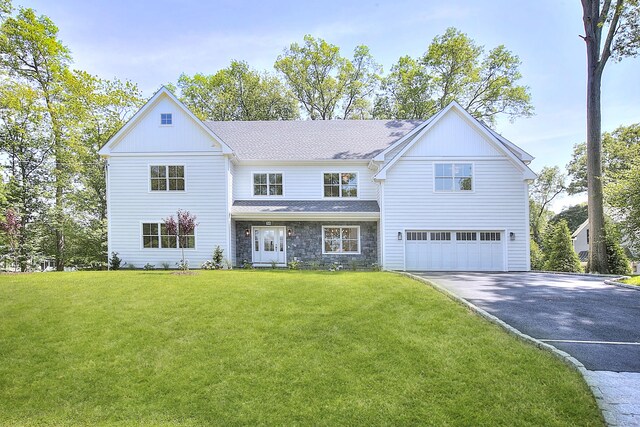 59 Thornhill Rd, Fairfield, CT 06824 - view of front of property with asphalt driveway, a garage, stone siding, and a front yard