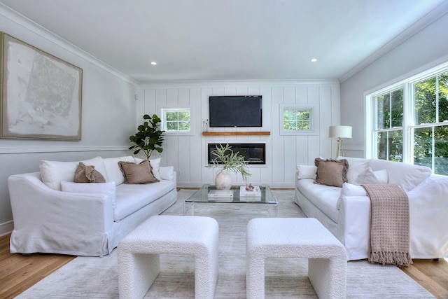 59 Thornhill Rd, Fairfield, CT 06824 - living area featuring ornamental molding, wood finished floors, a decorative wall, a glass covered fireplace, and recessed lighting