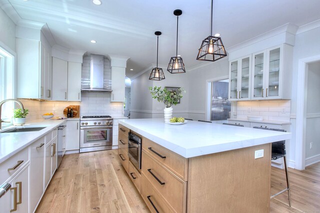 59 Thornhill Rd, Fairfield, CT 06824 - kitchen with wall chimney range hood, stainless steel appliances, a center island, backsplash, and glass insert cabinets