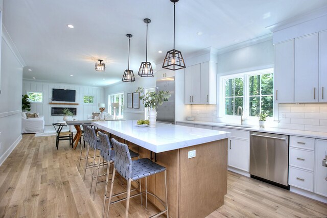 59 Thornhill Rd, Fairfield, CT 06824 - kitchen with stainless steel dishwasher, light wood-style floors, backsplash, plenty of natural light, and recessed lighting