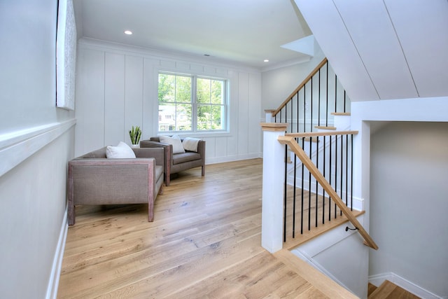 59 Thornhill Rd, Fairfield, CT 06824 - living area with stairway, wood finished floors, a decorative wall, and ornamental molding