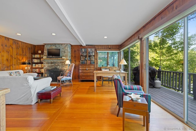 159 Mountain Rd, Ridgefield, CT 06877 - living area with wooden walls, healthy amount of natural light, a stone fireplace, light wood-style floors, and beamed ceiling