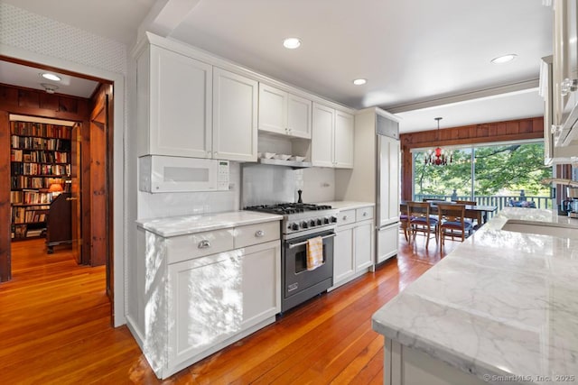 159 Mountain Rd, Ridgefield, CT 06877 - kitchen featuring high end appliances, white cabinetry, light wood-style floors, light stone counters, and recessed lighting