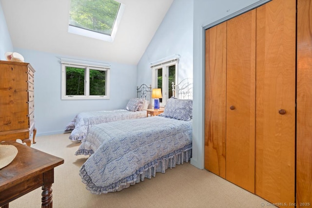 159 Mountain Rd, Ridgefield, CT 06877 - carpeted bedroom featuring a skylight, high vaulted ceiling, a closet, and baseboards