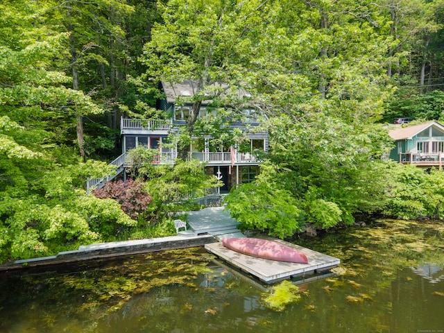 159 Mountain Rd, Ridgefield, CT 06877 - dock area featuring stairs, a view of trees, and a water view