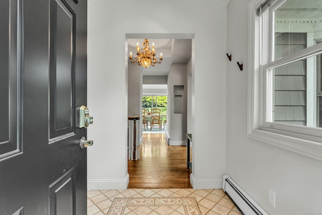15 Hallsey Ln, Woodbridge, CT 06525 - foyer entrance with inlaid floor details, baseboard heating, light tile patterned flooring, and a chandelier