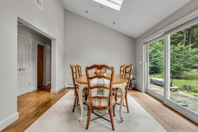 15 Hallsey Ln, Woodbridge, CT 06525 - dining area featuring a baseboard radiator, a skylight, light wood-style floors, and high vaulted ceiling