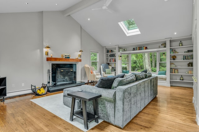 15 Hallsey Ln, Woodbridge, CT 06525 - living area with a premium fireplace, a skylight, beamed ceiling, light wood-style floors, and a ceiling fan