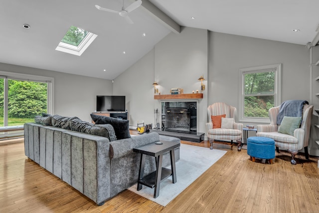 15 Hallsey Ln, Woodbridge, CT 06525 - living room featuring light wood finished floors, a skylight, healthy amount of natural light, high vaulted ceiling, and beam ceiling