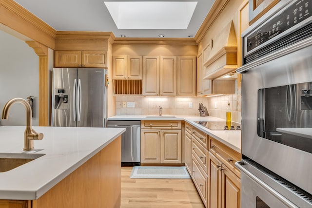 15 Hallsey Ln, Woodbridge, CT 06525 - kitchen featuring stainless steel appliances, a skylight, light countertops, light brown cabinets, and ornamental molding