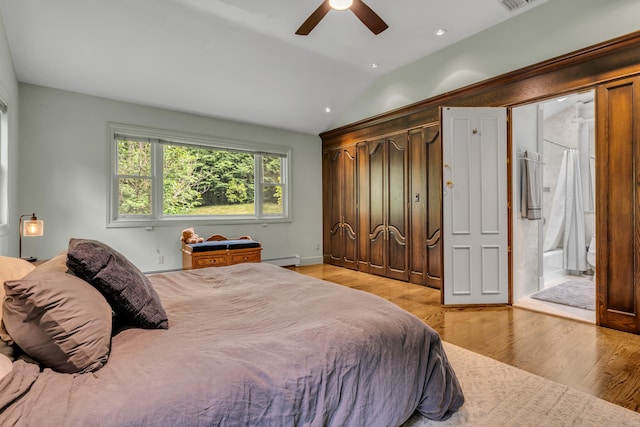 15 Hallsey Ln, Woodbridge, CT 06525 - bedroom featuring vaulted ceiling, light wood-type flooring, ensuite bath, a baseboard radiator, and ceiling fan