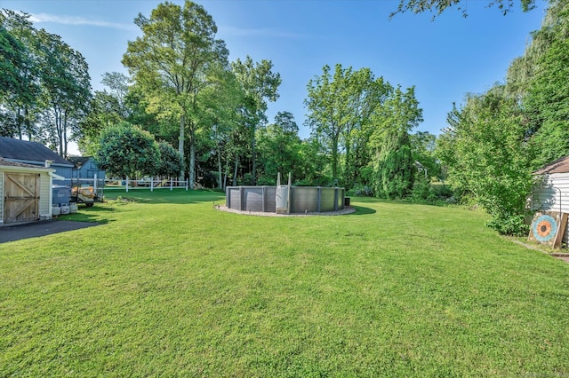6 Victoria Rd, Portland, CT 06480 - view of grassy yard with a storage shed and an outdoor pool