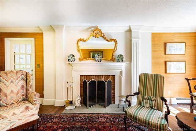 1493 Bucks Hill Rd, Southbury, CT 06488 - living area with baseboard heating, wood finished floors, ornamental molding, and a brick fireplace