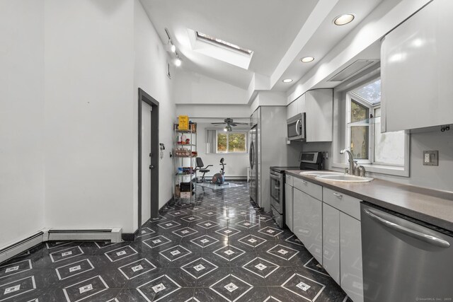 7 Lorma Ave, Trumbull, CT 06611 - kitchen featuring appliances with stainless steel finishes, a sink, vaulted ceiling, healthy amount of natural light, and dark floors