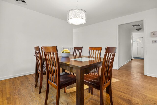 7 Lorma Ave, Trumbull, CT 06611 - dining area featuring light wood-type flooring, baseboards, and a chandelier
