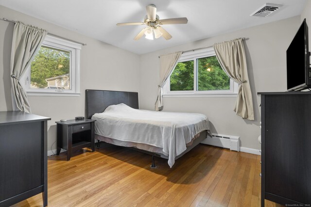 7 Lorma Ave, Trumbull, CT 06611 - bedroom featuring light wood-type flooring, multiple windows, baseboard heating, and baseboards