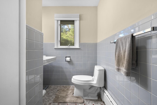 7 Lorma Ave, Trumbull, CT 06611 - half bath featuring toilet, tile walls, baseboard heating, wainscoting, and tile patterned flooring