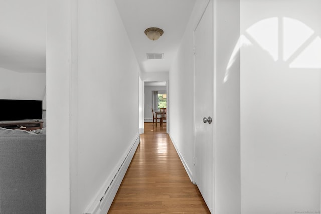 7 Lorma Ave, Trumbull, CT 06611 - hall with a baseboard heating unit, wood finished floors, and baseboards