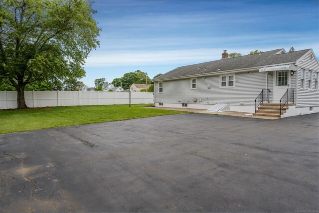 34 River St, East Haven, CT 06512 - rear view of house featuring entry steps, a chimney, and a shingled roof