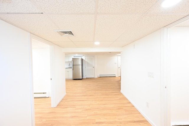 34 River St, East Haven, CT 06512 - hall featuring a baseboard heating unit, a paneled ceiling, light wood-type flooring, baseboards, and a sink