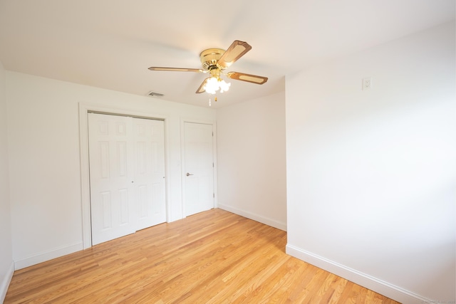 34 River St, East Haven, CT 06512 - unfurnished bedroom featuring light wood-style flooring, baseboards, a closet, and a ceiling fan