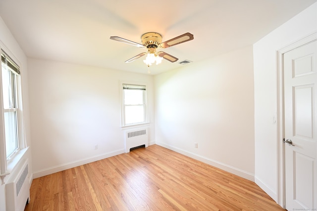 34 River St, East Haven, CT 06512 - empty room with radiator, light wood finished floors, ceiling fan, and baseboards