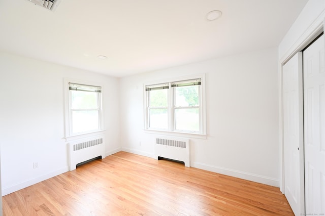 34 River St, East Haven, CT 06512 - unfurnished bedroom with radiator heating unit, light wood-style flooring, and baseboards