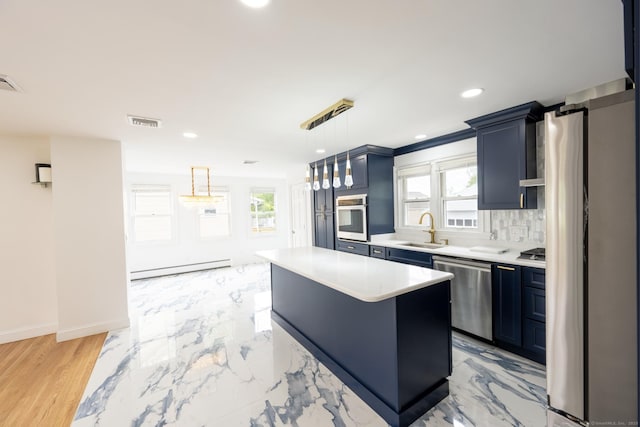 34 River St, East Haven, CT 06512 - kitchen featuring appliances with stainless steel finishes, baseboard heating, light countertops, a sink, and a center island