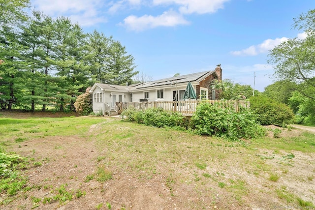 18 Robbie Rd, East Haddam, CT 06469 - back of property with a wooden deck and a chimney