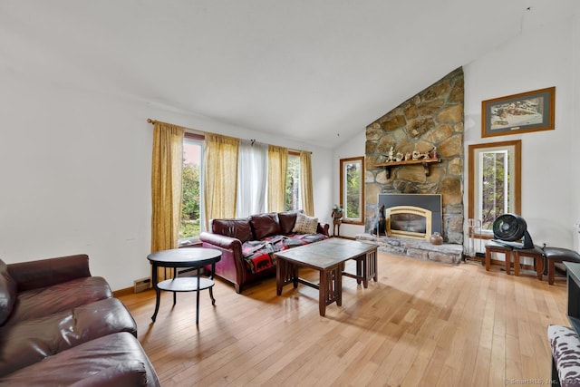 18 Robbie Rd, East Haddam, CT 06469 - living room with light wood-type flooring, a stone fireplace, high vaulted ceiling, and baseboard heating