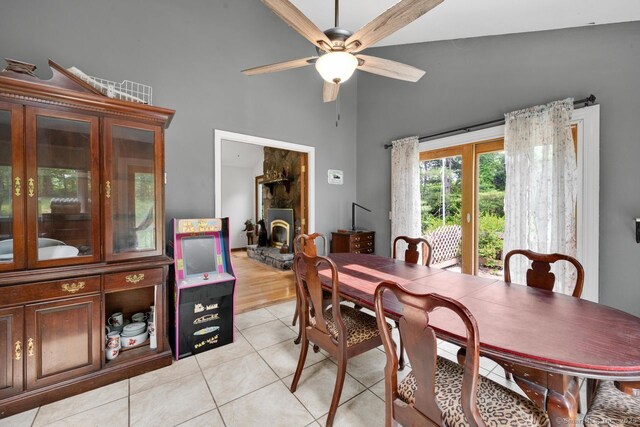 18 Robbie Rd, East Haddam, CT 06469 - dining space featuring high vaulted ceiling, light tile patterned floors, ceiling fan, and a wood stove
