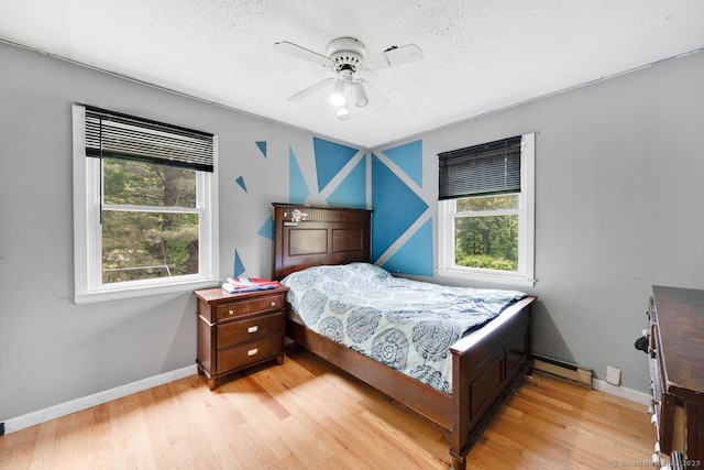 18 Robbie Rd, East Haddam, CT 06469 - bedroom featuring multiple windows, baseboards, light wood-style floors, and a textured ceiling