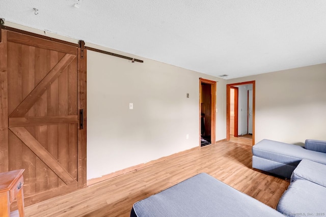 18 Robbie Rd, East Haddam, CT 06469 - living room with a barn door and light wood-style floors