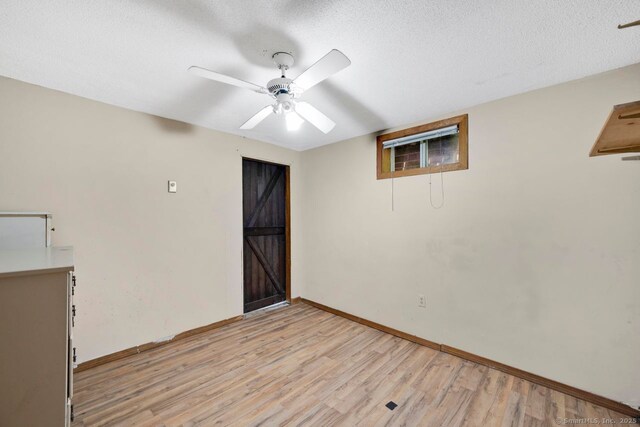 18 Robbie Rd, East Haddam, CT 06469 - unfurnished room featuring ceiling fan, light wood-style floors, baseboards, and a textured ceiling