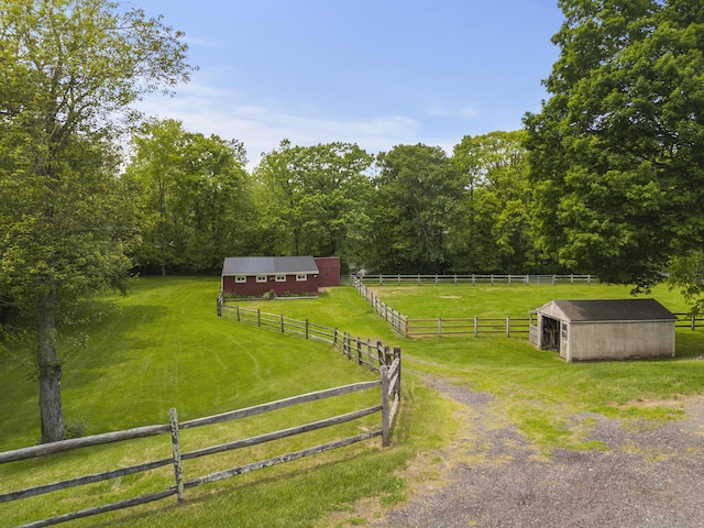 view of yard featuring an outdoor structure, a view of countryside, and a pole building