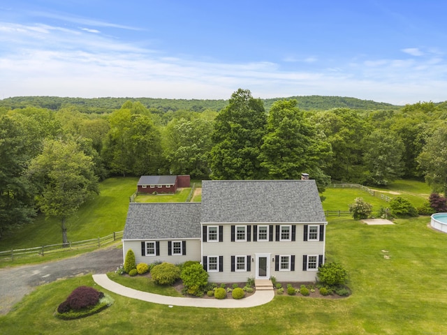 view from above of property with a heavily wooded area