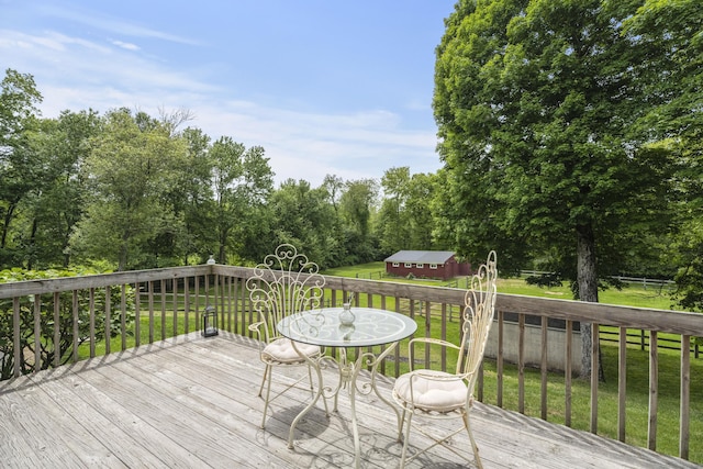 wooden deck with a lawn and an outbuilding