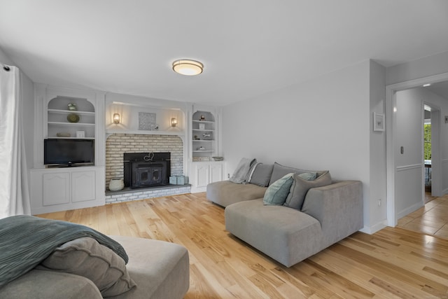 living area with wood finished floors, built in features, and baseboards