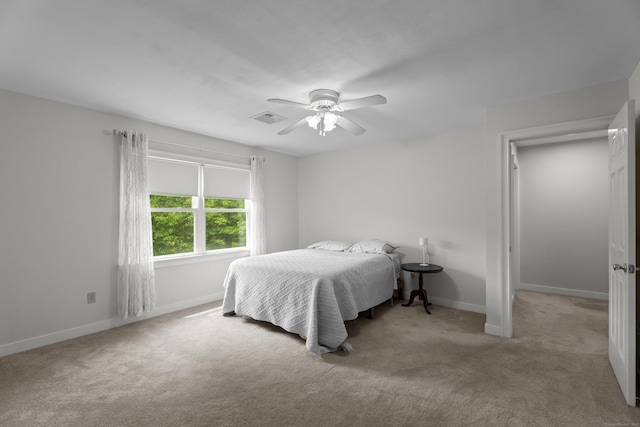 carpeted bedroom featuring baseboards and ceiling fan