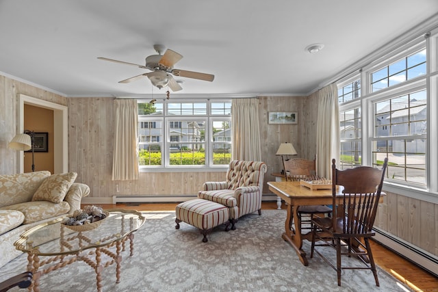 5 Oakwood Rd, Old Saybrook, CT 06475 - living room with a baseboard heating unit, wood finished floors, crown molding, plenty of natural light, and wood walls
