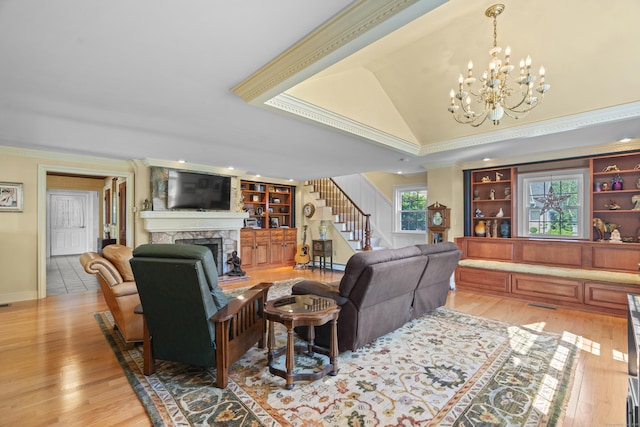 5 Oakwood Rd, Old Saybrook, CT 06475 - living room with crown molding, stairway, a fireplace, light wood finished floors, and lofted ceiling