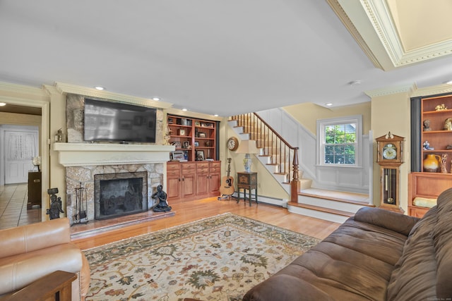 5 Oakwood Rd, Old Saybrook, CT 06475 - living room featuring crown molding, wood finished floors, stairway, baseboard heating, and built in features