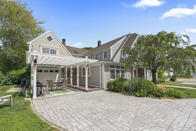 5 Oakwood Rd, Old Saybrook, CT 06475 - rear view of house with a pergola, a patio area, a chimney, an attached garage, and a yard