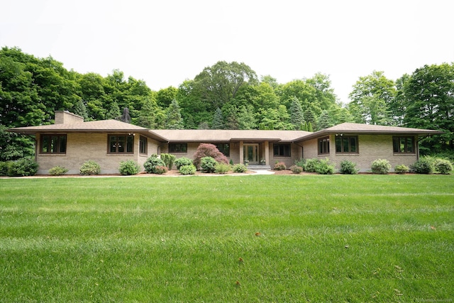 70R Tri Mountain Rd, Durham, CT 06422 - single story home with brick siding, a front lawn, and a chimney