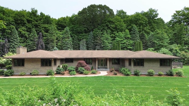 70R Tri Mountain Rd, Durham, CT 06422 - ranch-style home with a chimney, a front lawn, brick siding, and a wooded view
