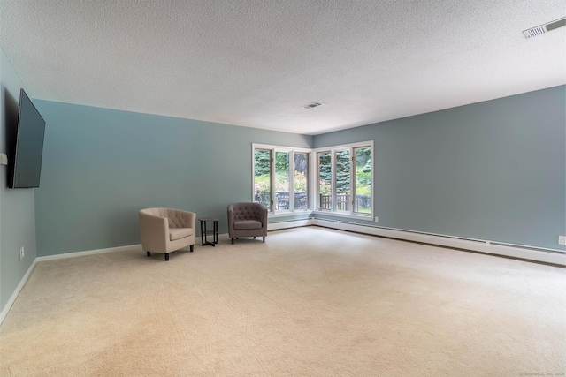 70R Tri Mountain Rd, Durham, CT 06422 - sitting room featuring a baseboard heating unit, carpet floors, baseboard heating, baseboards, and a textured ceiling