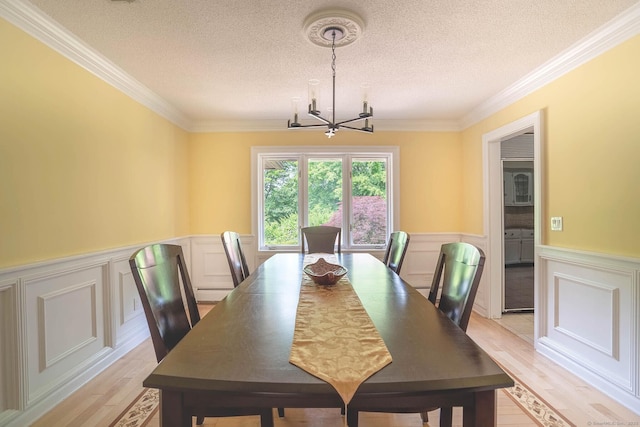 70R Tri Mountain Rd, Durham, CT 06422 - dining room with a chandelier, wainscoting, a textured ceiling, light wood finished floors, and ornamental molding