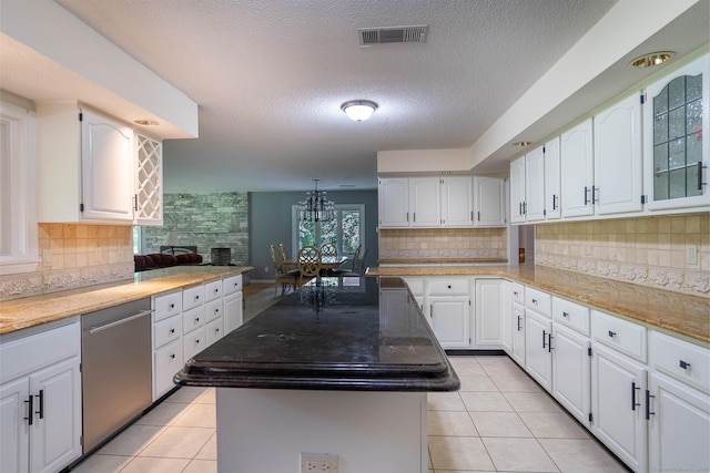 70R Tri Mountain Rd, Durham, CT 06422 - kitchen featuring stainless steel dishwasher, light tile patterned floors, a center island, backsplash, and a textured ceiling