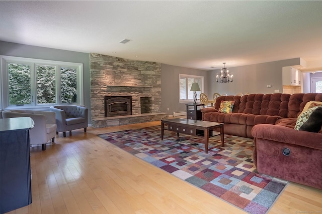 70R Tri Mountain Rd, Durham, CT 06422 - living area featuring a baseboard radiator, hardwood / wood-style flooring, a fireplace, and a chandelier